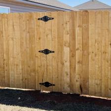 Happy-customers-and-a-beautiful-Pre-stained-Douglas-Fir-wood-fence-finalized-in-Yukon 1