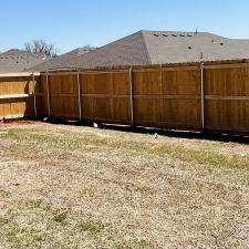 Happy-customers-and-a-beautiful-Pre-stained-Douglas-Fir-wood-fence-finalized-in-Yukon 0