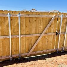 Happy-customers-and-a-beautiful-Pre-stained-Douglas-Fir-wood-fence-finalized-in-Yukon 2