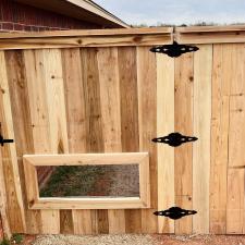 Perfectly-Crafted-customized-fence-installation-in-Midwest-City-Complete-with-a-personalized-dog-window-and-stainseal 6