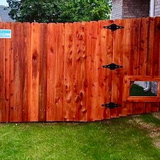 Redwood-Stain-job-on-a-brand-new-Cedar-fence 1